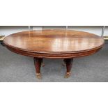 A 19th century Anglo Indian teak dining table, the oval top on four spiral fluted supports,