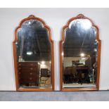 A pair of 20th century mahogany framed arch top wall mirrors, with bevelled glass,
