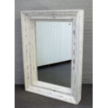 A large modern rectangular mirror with deep moulded distresses white painted frame,