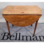 A Regency mahogany oval Pembroke table, with single frieze drawer on turned supports,