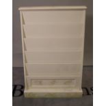 A 20th century white painted slope fronted child's open bookcase, 76cm wide x 112cm high.