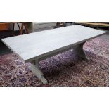 A Swedish grey painted rectangular kitchen table on shaped trestle end standards,