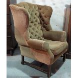 A George II style mahogany framed wingback armchair, on square supports, 84cm wide x 110cm high.