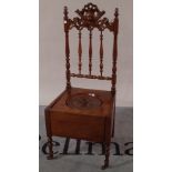 A Victorian mahogany commode chair on turned supports, 41cm wide x 97cm high.