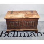 An 18th century style oak lift top box with carved panel decoration, 82cm wide x 48cm high.