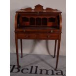 An Edwardian inlaid mahogany cylindrical desk with two short drawers on tapering square supports,