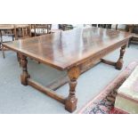 A 17th century style oak refectory table, the cleated plank top on turned supports,