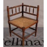 A 19th century stained beech bobbin turned corner chair, 61cm wide x 70cm high.