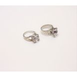 A colourless gem set solitaire ring, having engraved decoration to the shoulders,
