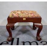 A Victorian mahogany framed rectangular footstool on ball and claw feet, 46cm wide x 40cm high.