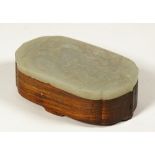 A Chinese hardwood box with jade cover, late 19th/20th century, of shaped oblong form,