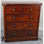 A Victorian mahogany chest of two short and three long graduated drawers on bun feet.