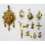 Nine mostly 9ct gold and 9ct gold mounted charms, including; a stork, a fish and an aeroplane,