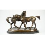 A modern patinated bronze equestrian group depicting two horses on a naturalistic base and marble