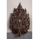 A 20th century carved hardwood hanging shelf, 50cm wide x 75cm high.