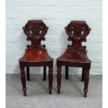 A pair of early Victorian mahogany hall chairs,