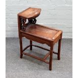 An early 20th century Chinese hardwood two tier side table, with pierced decoration,