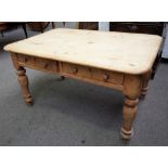 A Victorian pine kitchen table with a pair of frieze drawers on turned supports,