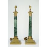 A pair of Victorian style faux Verde marble and brass mounted table lamps of Corinthian column form,