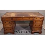 A 19th century mahogany pedestal desk with nine drawers about the knee, on bracket feet,
