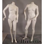 A pair of modern white adult women shop mannequins.