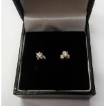 A near pair of diamond single stone earstuds, each claw set with a circular cut diamond,