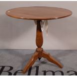 A 19th century walnut tripod table with dished circular top, on outswept supports,
