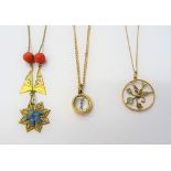 A gold mounted compass pendant, with a gold curb link neckchain, on a cylindrical clasp, a gold,