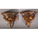 A pair of Victorian style serpentine gilt wood wall shelves, 28cm wide x 30cm high, (2) (a.f.).