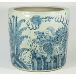 A large Chinese blue and white pottery jardiniere decorated with temple dogs against a landscape,