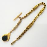 A Victorian gold watch Albert chain, in a decorated twin bar,