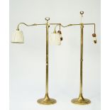 A pair of Victorian style brass adjustable floor lamps, modern with angle poise arms,