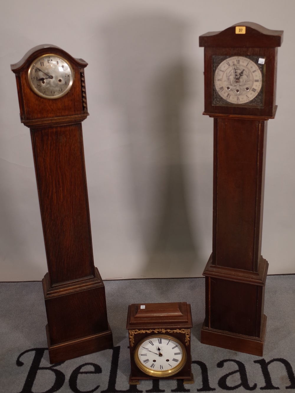 An early 20th century 8 day oak longcase clock, 27cm wide x 135cm high and another similar,