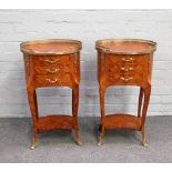 A pair of French gilt metal mounted parquetry inlaid kingwood oval three drawer bedside tables,