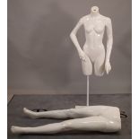A female mannequin torso and a pair of legs.