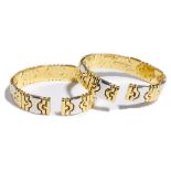 A pair of Italian two colour gold and diamond set sprung bangles,