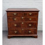 An early 18th century walnut chest of two short and three long graduated drawers on bracket feet,