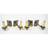 A set of four silvered metal modern single branch wall lights,