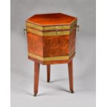 A George III brass bound mahogany hexagonal wine cooler with hinged lid on three tapering square