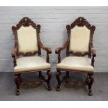 A pair of 17th century style carved oak open armchairs,