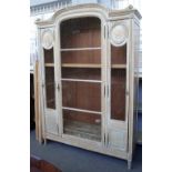 A French 19th century and later distressed painted beech display cabinet,