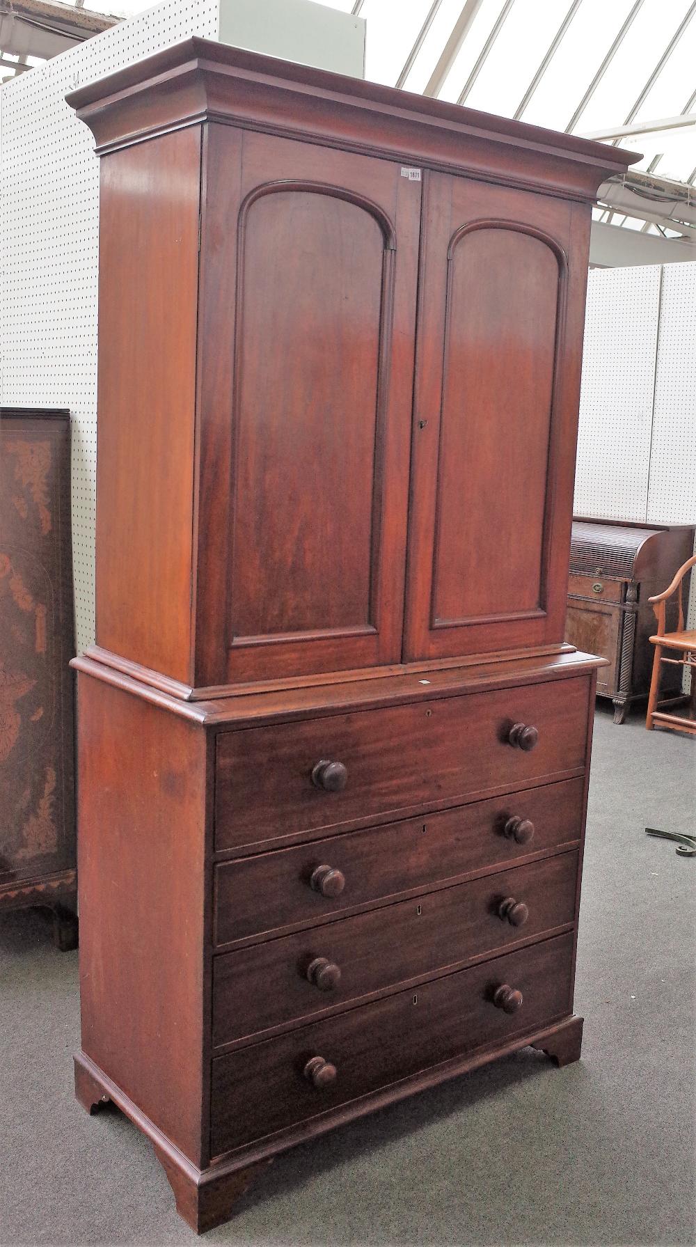 A George III mahogany secretaire cabinet, the pair of arch panel doors,