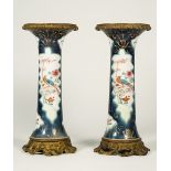 A pair of famille-rose blue ground gilt-metal mounted beaker vases, 19th/20th century,