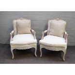 A pair of Louis XV style open armchairs with distressed white painted frames, 70cm wide x 92cm high.