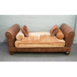 John Sankey; a modern studded brown leather upholstered day bed on tapering block supports,