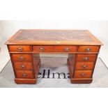 An early 20th century mahogany pedestal desk with nine drawers about the knee,