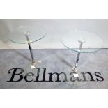 A pair of 20th century chrome and glass occasional tables, on circular glass plinth bases,