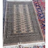 An Indian rug, the plain brown field with a lozenge medallion, grey spandrels, cross border,