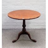 A George III mahogany tripod occasional table with circular snap top on turned and spiral fluted