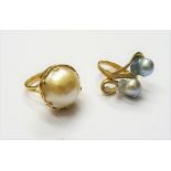 A gold, cultured pearl and diamond set single stone ring, in an abstract twist design,